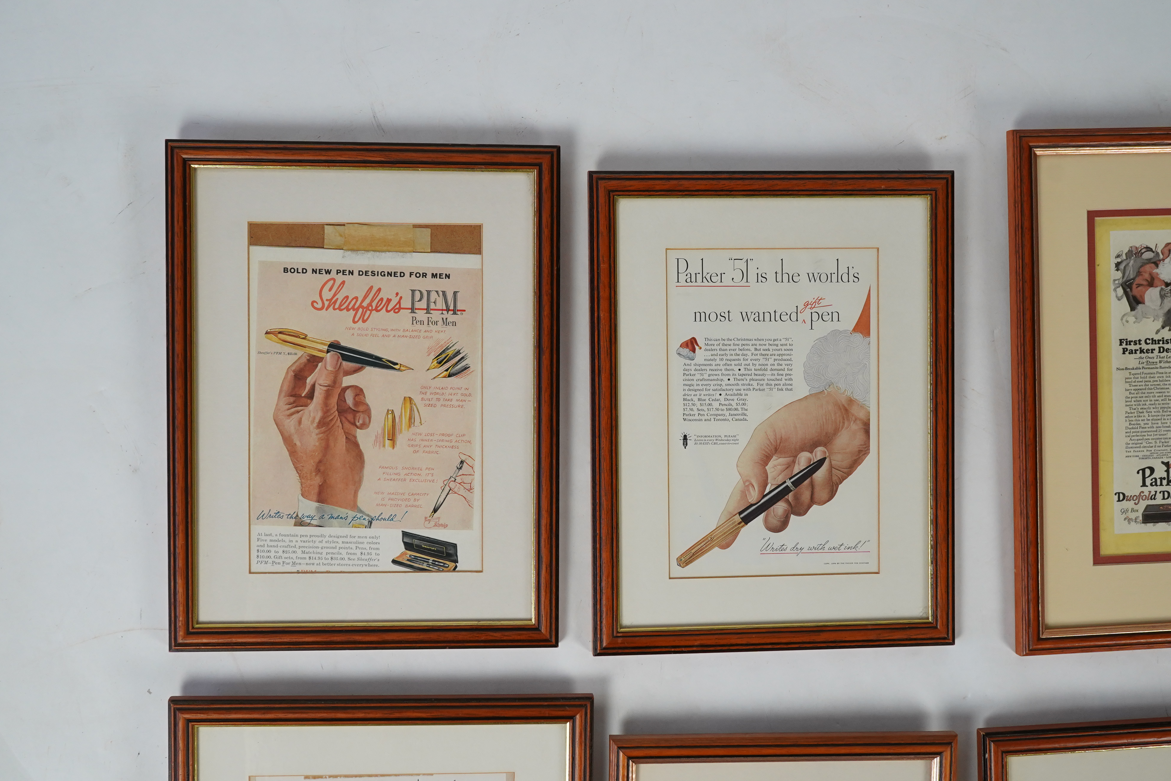 Framed fountain pen adverts (12)